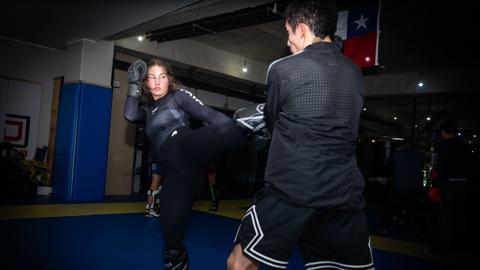 Entrenamiento BJJ mujer usando rashguard en grappling